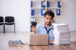 © Elnur - Young male employee and too much work in the office