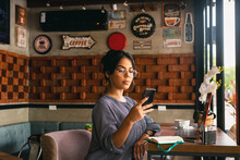 Woman Checking Her Cell Phone While Having Coffee, Chill Concept