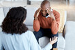 © Rene La/peopleimages.com - Black man, mental health and counseling with woman psychologist, stress headache and depression with help. Consultation, doctor with patient and conversation about anxiety problem, sad and depressed
