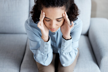 Wall Mural - Headache, stress and anxiety with black woman on sofa for burnout, mental health and sad. Depression, thinking and frustrated with girl in living room suffering with problem, worried and exhausted