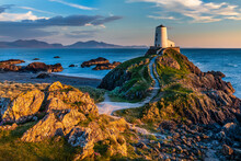 The Beautiful Twr Mawr Lighthouse At Sunset On The Island Of Ynys Llanddwyn In  Anglesey, North Wales.
