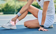 © Delcio/peopleimages.com - Tennis court, ankle pain and woman on sports ground for healthcare risk, foot or training problem. Competition, game and athlete with workout fail, mistake or accident massage muscle in red overlay
