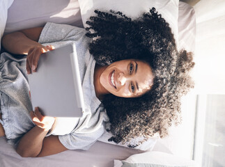 Canvas Print - Tablet, black woman and top view in bed in bedroom for social media, texting or internet browsing in the morning. Portrait, relax and female on digital touchscreen for web scrolling or networking.