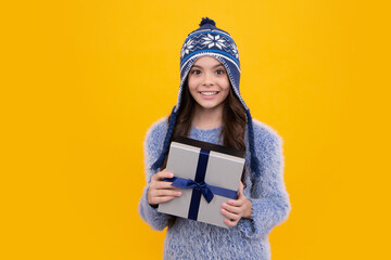 Poster - Teenager kid with present box. Teen girl giving birthday gift. Present, greeting and gifting concept. Happy face, positive and smiling emotions of teenager child.