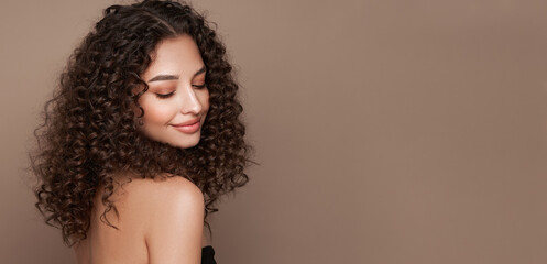 Fashion studio portrait of beautiful smiling woman with afro curly hairstyle. Fashion and beauty