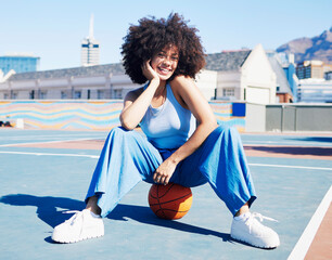 Sticker - Basketball court, fashion and portrait of black woman with smile in trendy, urban style and edgy clothes in city. Sports, fitness park and girl outdoors with ball for motivation, happy and confident