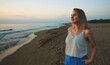© M-Production - Woman stands on deserted beach and looks into the distance.