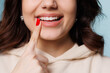 © Vadim - Happy girl showing toothy smile, pointing finger at healthy white teeth. Clinic patient satisfied with dentist service, enamel cleaning, whitening, dental care, correction. Cropped shot, close up