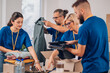 © Zamrznuti tonovi - Diverse volunteers working in a charity donation center and packing clothes and food