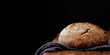Wheat artisan sourdough bread on a wooden table black background. Panoramic view, free space for text