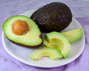 Wall Mural - Two fresh ripe raw hass avocados, close up, healthy food concept