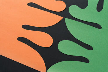 Poster - orange and green paper shapes with decorative organic edges on black paper