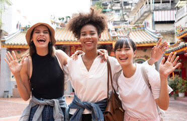group of multi-ethnic female friends diversity enjoying the city tour. young tourists having fun in 