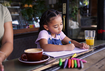 Girl child color in book at cafe, creative and drawing with crayons, family day to relax with learning and art in Atlanta. Young kid, growth and writing, education and creativity while at coffee shop