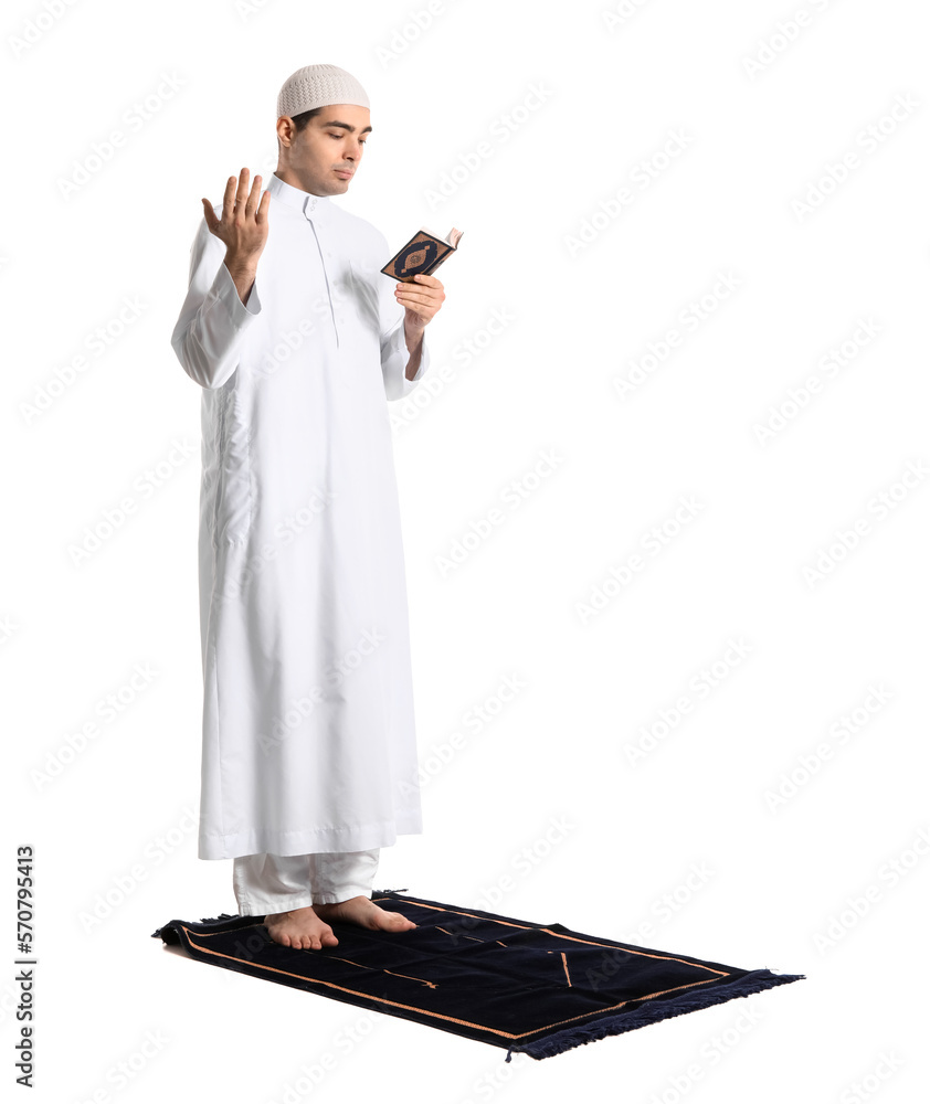 Praying Muslim man with Koran on white background