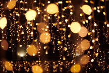 Yellow Lights Bokeh From Christmas Holiday Garlands, Blurred Festive Background, Abstract Outdoor Lights With Boke. Bright Yellow Bokeh Lights With Beautiful Shiny On Dark Night Background
