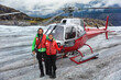 © Maridav - Alaska helicopter tour tourist couple on cruise excursion glacier hike activity in Skagway, Alaska, USA travel. Tourists portrait on helicopter ride in mountains landscape on summer vacation.