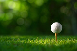 Close-up golf ball on tee with blur green bokeh background.