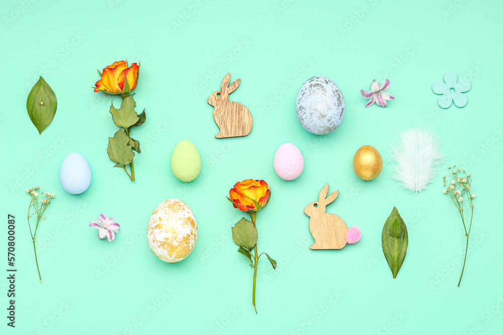 Composition with Easter eggs, flowers and decor on color background