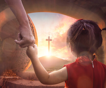 easter concept: child's hand holding mother's finger on blurred the cross of jesus christ background
