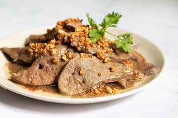 Wall Mural - Fried pork liver with garlic on white plate. 