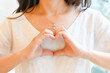 © joy - Woman making hand in heart shape, self love, self care. Mindfulness spiritual living lifestyle.