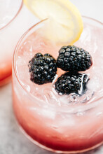 High Angle Detail Of A Bramble Cocktail With Blackberries And Lemon