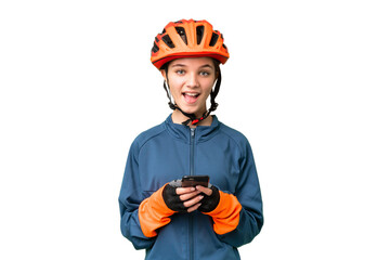 Sticker - Teenager cyclist girl over isolated chroma key background surprised and sending a message