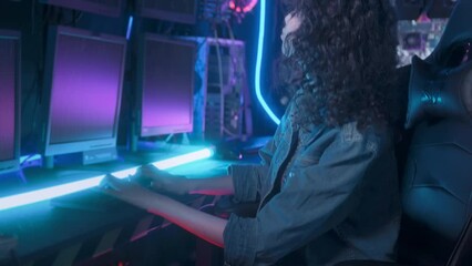 an asian woman programmer is working in her computer room , futuristic technology concept