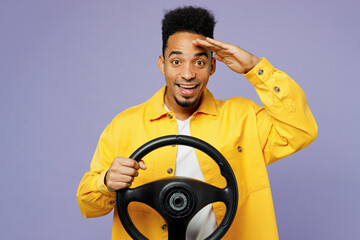 Wall Mural - Young smiling man of African American ethnicity wear yellow shirt t-shirt hold steering wheel drive car hold hand at forehead isolated on plain pastel light purple background People lifestyle concept