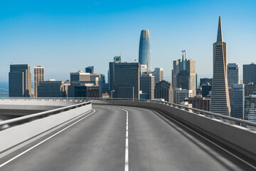 Empty urban asphalt road exterior with city buildings background. New modern highway concrete construction. Concept way to success. Transportation logistic industry fast delivery. San Francisco. USA.