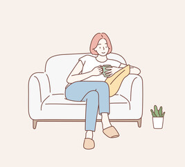 Beautiful young woman sitting on sofa at home with cup. Hand drawn style vector design illustrations.