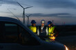 © EFStock - Team of technicians and engineer working in wind turbine farm at night, planing renewable energy ecology project
