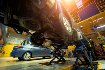 Wall Mural - Car on hydraulic lift in auto repair shop