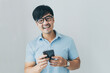 © panitan - adult asian man using mobile, cell phone.young male person.posing smiling laughing look excited surprised thinking positive happy.empty,copy space for text advertising.white background
