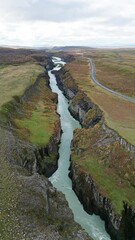 Wall Mural - Drone flying directly above amazing huge beautiful waterfall Gullfoss, Iceland