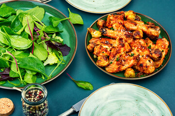 Wall Mural - Baked chicken wings and green salad