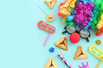 Purim celebration concept (jewish carnival holiday) over blue background. Top view, flat lay