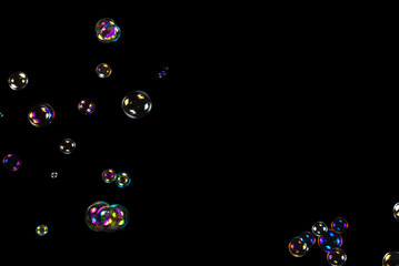 Sticker - Soap bubbles isolated on a black background