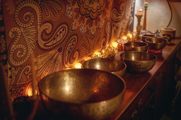 beautiful tibetan bowl on a wooden shelf, ceremonial space.