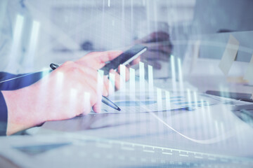 Poster - Double exposure of man's hands holding and using a phone and financial chart drawing. Market analysis concept.