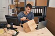 © Krakenimages.com - Young hispanic man ecommerce business worker scanning package at office
