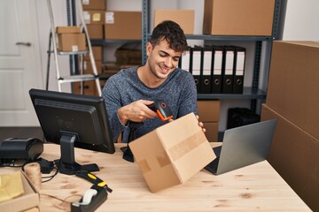 Poster - Young hispanic man ecommerce business worker scanning package at office