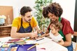 © Krakenimages.com - Couple and daughter smiling confident drawing at art studio