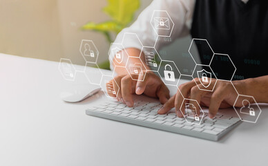 Fototapete - A businessman works on his laptop at home with a virtual display showing a symbol to signify cyber security privacy and online data protection
