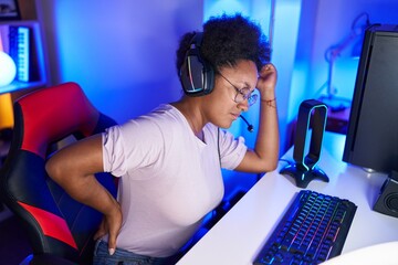 Canvas Print - African american woman streamer stressed suffering for backache at gaming room