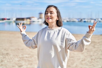 Sticker - Middle age woman smiling confident training yoga at seaside