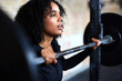 © Flamingo Images - Fit woman standing with weights in a gym