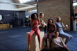 © Flamingo Images - Group of diverse female friends laughing in a gym. Women working out