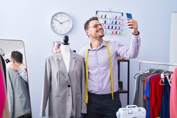 Sticker - Young hispanic man tailor smiling confident make selfie by smartphone at tailor shop